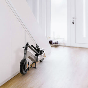 Pure Advance+ Electric Scooter folded in hallway - Platinum